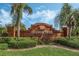 Community entrance sign for Orange Tree with palm trees and lush landscaping on a sunny day at 16014 Hawk Hill St, Clermont, FL 34714
