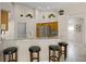 Kitchen bar area with granite countertops and stainless steel appliances at 16014 Hawk Hill St, Clermont, FL 34714