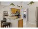 Open kitchen with granite counters, wooden cabinets, and breakfast bar seating at 16014 Hawk Hill St, Clermont, FL 34714