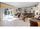 Bright living room with sliding glass doors leading to a screened patio and pool area at 16014 Hawk Hill St, Clermont, FL 34714