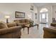 Inviting living room with tile floors, comfortable seating, and a view of the front entrance at 16014 Hawk Hill St, Clermont, FL 34714
