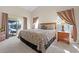 Cozy main bedroom with plush bedding, carpeting and sliding door to the pool at 16014 Hawk Hill St, Clermont, FL 34714