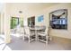 Covered screened patio featuring comfortable outdoor seating and a dining table at 16014 Hawk Hill St, Clermont, FL 34714