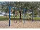 Neighborhood swings at the playground with a nice green space, and mature trees at 16014 Hawk Hill St, Clermont, FL 34714