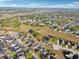 A high level aerial view of the neighborhood, displaying the layout of homes, streets, and green spaces at 16035 Wilkinson Dr, Clermont, FL 34714