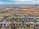 Expansive aerial view of a residential community with diverse homes, tree coverage, and open spaces on a sunny day at 16035 Wilkinson Dr, Clermont, FL 34714
