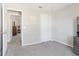 This carpeted bedroom leads to another room and features a closet at 16035 Wilkinson Dr, Clermont, FL 34714