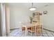 Dining room with a neutral palette and seating for six. Contemporary lighting fixture above at 16035 Wilkinson Dr, Clermont, FL 34714