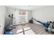 Home exercise room with wood floor, window, ceiling fan and exercise equipment at 16035 Wilkinson Dr, Clermont, FL 34714