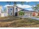 Charming two-story home with a well-manicured lawn and a two-car garage offers great curb appeal at 16035 Wilkinson Dr, Clermont, FL 34714