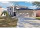 Attractive two-story home with a spacious driveway leading to an attached two-car garage at 16035 Wilkinson Dr, Clermont, FL 34714