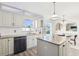 Kitchen with granite countertops, an island, stainless steel appliances, and backyard views at 16035 Wilkinson Dr, Clermont, FL 34714