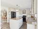 Bright kitchen with a granite island, stainless appliances, and an open layout to the dining area at 16035 Wilkinson Dr, Clermont, FL 34714