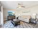 Comfortable living room featuring a ceiling fan, large tv, and neutral patterned rug at 16035 Wilkinson Dr, Clermont, FL 34714