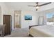Neutral toned main bedroom with views and a mounted tv on the wall at 16035 Wilkinson Dr, Clermont, FL 34714