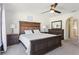 Spacious main bedroom suite boasting dark wood furniture and a ceiling fan at 16035 Wilkinson Dr, Clermont, FL 34714