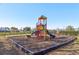 A community playground featuring colorful play structures, climbing apparatus, and a mulch ground cover at 16035 Wilkinson Dr, Clermont, FL 34714