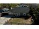 Aerial perspective of a compact home with a long driveway, small front yard, and mature trees at 1756 Elbert Acres Ne Ct, Winter Haven, FL 33881