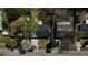 This aerial view displays a home with a backyard, a detached building, and mature trees offering shade at 1756 Elbert Acres Ne Ct, Winter Haven, FL 33881