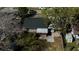 The aerial image captures backyard showing a detached structure and patio area shaded by mature trees at 1756 Elbert Acres Ne Ct, Winter Haven, FL 33881