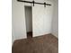 Cozy bedroom features a white barn door leading to the closet at 1756 Elbert Acres Ne Ct, Winter Haven, FL 33881