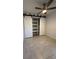 Bedroom featuring a ceiling fan and unique closet with sliding barn doors at 1756 Elbert Acres Ne Ct, Winter Haven, FL 33881