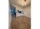 Dining room features neutral walls, wood-look tile flooring, and overhead chandelier at 1756 Elbert Acres Ne Ct, Winter Haven, FL 33881