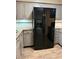 Kitchen featuring gray cabinets, durable countertops, and a modern black refrigerator at 1756 Elbert Acres Ne Ct, Winter Haven, FL 33881