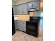 Cozy kitchen featuring gray cabinetry, practical countertops, and modern appliances at 1756 Elbert Acres Ne Ct, Winter Haven, FL 33881
