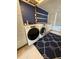 Laundry area featuring side-by-side washer and dryer with overhead cabinetry and a stylish blue rug at 1756 Elbert Acres Ne Ct, Winter Haven, FL 33881