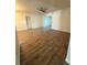Open-concept living room featuring wood-look tile flooring and recessed lighting at 1756 Elbert Acres Ne Ct, Winter Haven, FL 33881