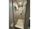Narrow shower stall with tile and accent tile, step-in and adjustable shower head at 1756 Elbert Acres Ne Ct, Winter Haven, FL 33881