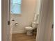 Cozy half-bath features wood-look flooring and neutral paint, perfect for guests at 1767 Smarts Rule St, Kissimmee, FL 34744