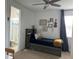Cozy bedroom featuring a bathroom, ceiling fan, and natural light at 1767 Smarts Rule St, Kissimmee, FL 34744