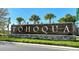 Entrance sign displaying the community name 'Tohoqua' with stone base and manicured landscaping at 1767 Smarts Rule St, Kissimmee, FL 34744