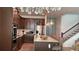 Modern kitchen features stainless steel appliances, an island with seating, and elegant pendant lighting at 1767 Smarts Rule St, Kissimmee, FL 34744