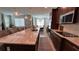 Open kitchen with granite counters, stainless appliances, hardwood style floors, and a long island with seating at 1767 Smarts Rule St, Kissimmee, FL 34744