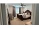 Comfortable main bedroom features an ornate headboard, carpet, and soft natural light at 1767 Smarts Rule St, Kissimmee, FL 34744