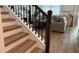 Staircase with dark metal balusters and wood treads adjacent to living room at 1767 Smarts Rule St, Kissimmee, FL 34744
