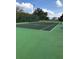 Community tennis court surrounded by a chain-link fence and well-maintained landscaping at 1767 Smarts Rule St, Kissimmee, FL 34744