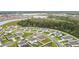 A captivating aerial view of a residential area near a lush green forest and tranquil lake at 202 Zircon Rd, Kissimmee, FL 34758