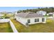 View of the backyard with sliding glass doors and lush green lawn at 202 Zircon Rd, Kissimmee, FL 34758