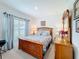 Inviting bedroom features wood furniture and a view to the backyard at 202 Zircon Rd, Kissimmee, FL 34758