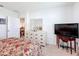 Bedroom featuring dresser, bed, TV, and an open doorway to another room at 202 Zircon Rd, Kissimmee, FL 34758