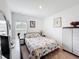 Cozy bedroom with neutral tones, features a patterned bedspread and simple decor at 202 Zircon Rd, Kissimmee, FL 34758