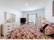 Comfortable bedroom with decorative pillows, dresser, TV, and lots of natural light at 202 Zircon Rd, Kissimmee, FL 34758