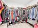 Walk-in closet with organized storage, shelves, hanging clothes and shoe racks at 202 Zircon Rd, Kissimmee, FL 34758