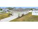 Well-kept house showing the garage and driveway with green grass surrounding the property at 202 Zircon Rd, Kissimmee, FL 34758