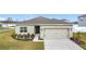 Charming single-story home with a well-maintained lawn and a two-car garage at 202 Zircon Rd, Kissimmee, FL 34758