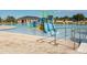 Community pool featuring water slides, zero entry, and expansive pool deck with a clubhouse in the background at 202 Zircon Rd, Kissimmee, FL 34758